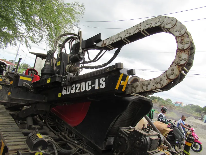 Close view of a tracked horizontal directional drill machine with drill rod carousel